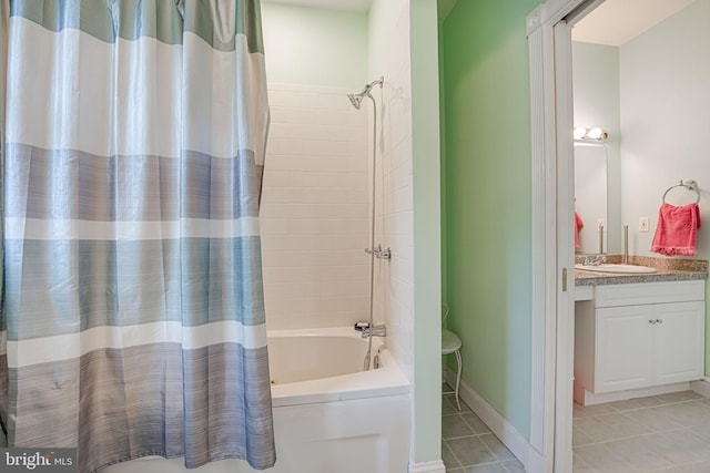 full bathroom with tile patterned flooring, baseboards, shower / tub combo, and vanity