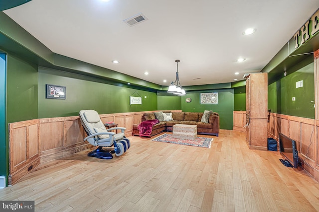 interior space featuring recessed lighting, a wainscoted wall, visible vents, and wood finished floors