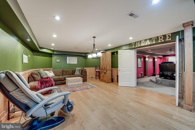 living room with light wood-style floors, visible vents, a wainscoted wall, and recessed lighting