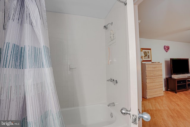 full bathroom featuring shower / bath combo with shower curtain and wood finished floors