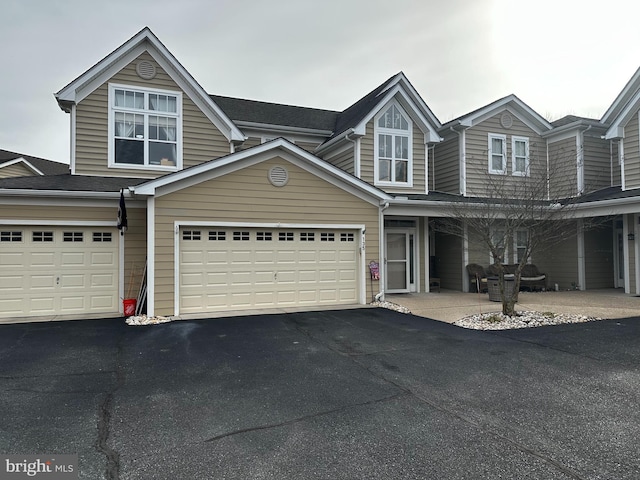 view of property featuring driveway and an attached garage