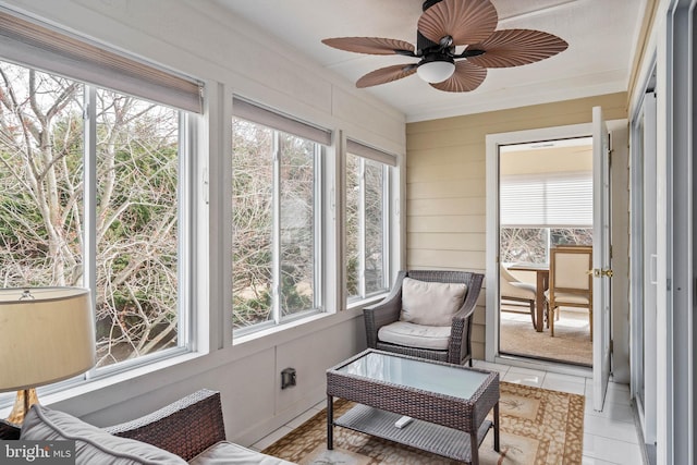 sunroom with plenty of natural light and a ceiling fan