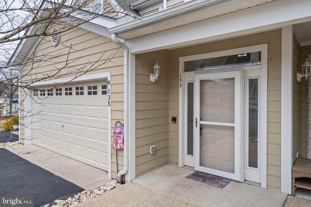 view of exterior entry with a garage