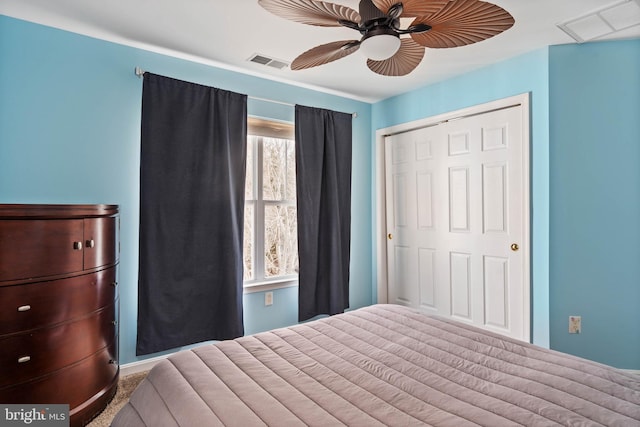 unfurnished bedroom with a closet, carpet flooring, visible vents, and a ceiling fan