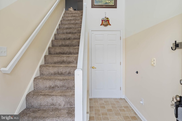 staircase featuring baseboards