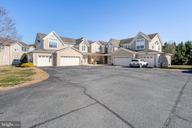 shingle-style home with a garage and a residential view