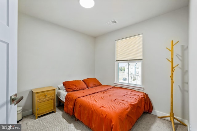 carpeted bedroom with baseboards and visible vents