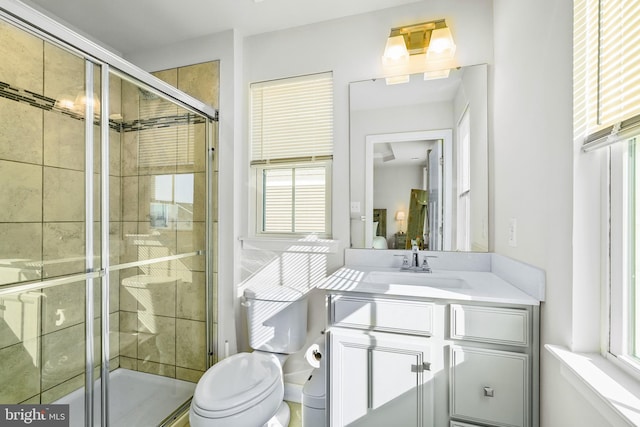 bathroom featuring toilet, ensuite bath, a shower stall, and vanity