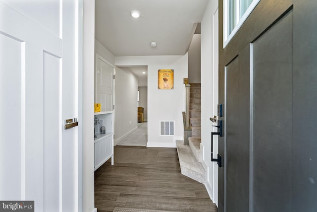 entryway featuring baseboards, visible vents, dark wood-style flooring, stairs, and recessed lighting