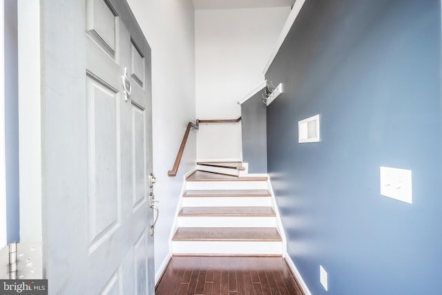 stairway with baseboards and wood finished floors