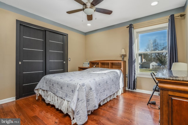 bedroom with recessed lighting, wood finished floors, and baseboards