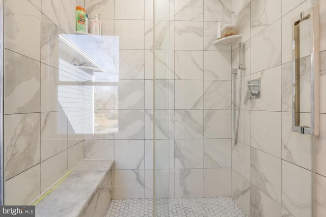 bathroom with tiled shower