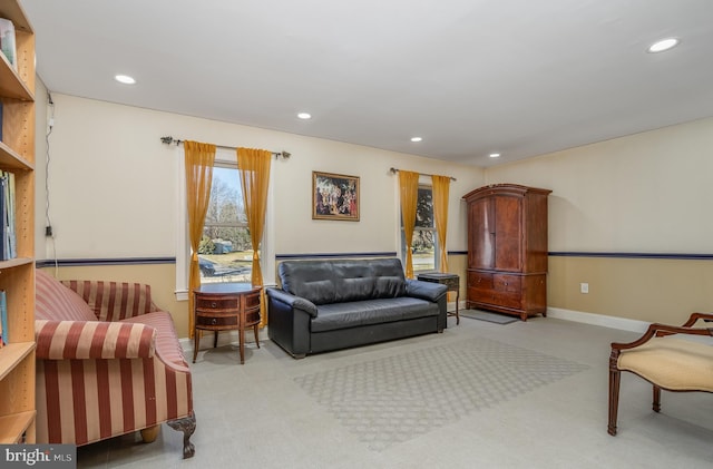 carpeted living area with baseboards and recessed lighting