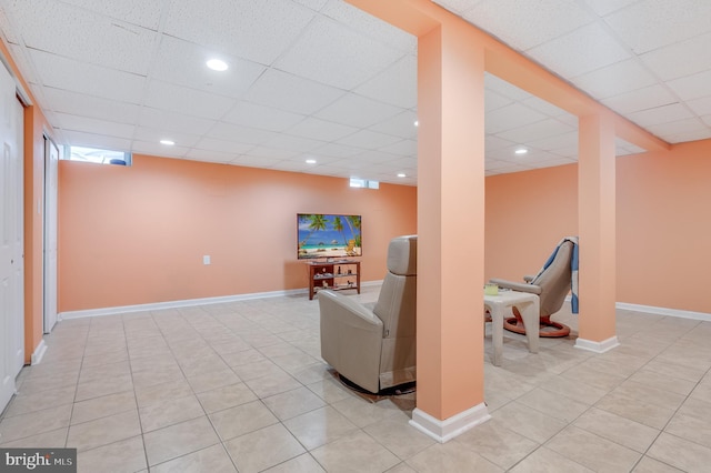 interior space with light tile patterned floors, baseboards, a drop ceiling, and recessed lighting