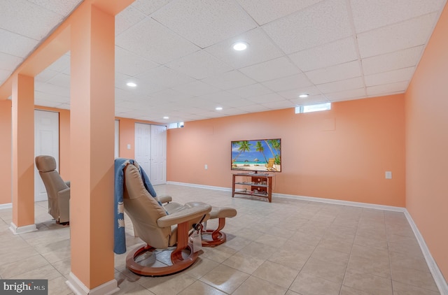 sitting room featuring light tile patterned floors, recessed lighting, a paneled ceiling, and baseboards