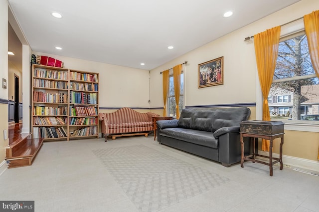 living area featuring baseboards and recessed lighting