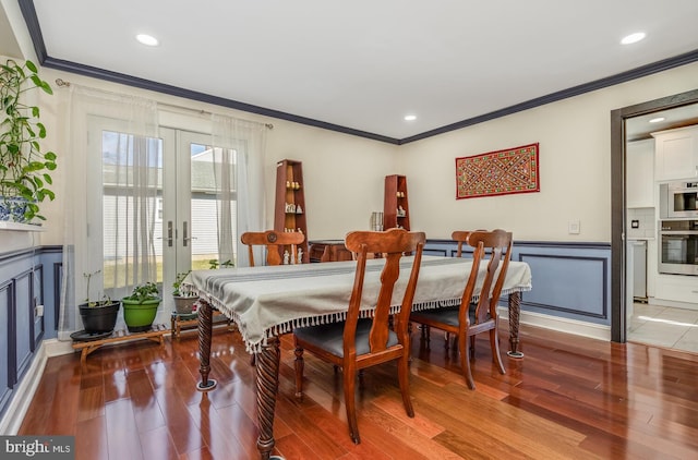 dining area with french doors, a wainscoted wall, recessed lighting, ornamental molding, and wood finished floors