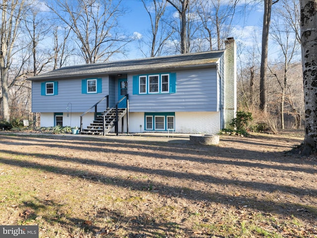 view of front of home featuring a front lawn and a chimney