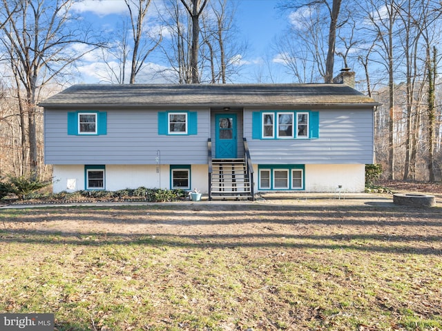 view of front of property with a chimney and a front lawn