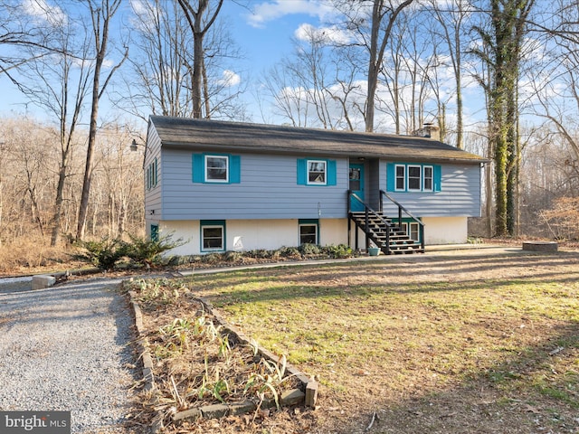 view of front of property featuring a chimney and a front yard