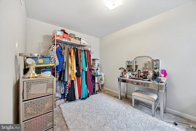 walk in closet with carpet