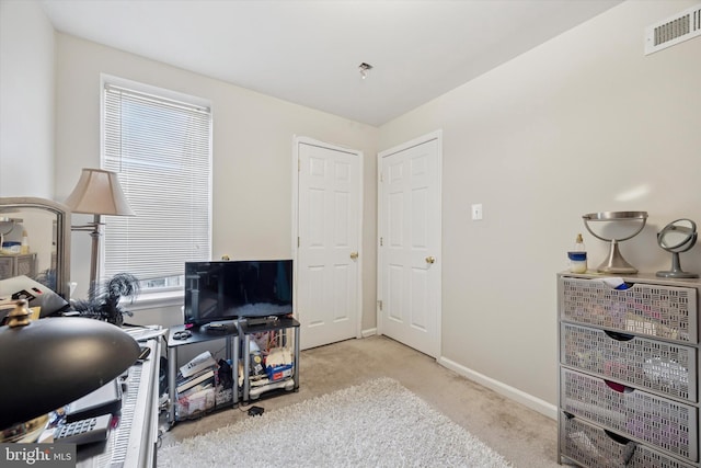 office area featuring baseboards, visible vents, and carpet flooring