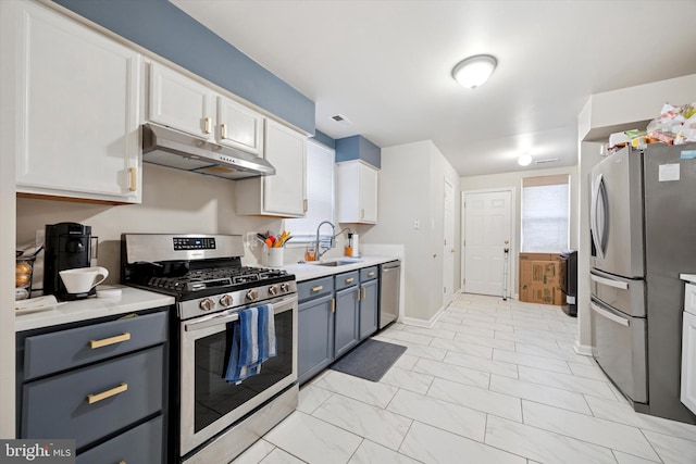 kitchen with visible vents, light countertops, appliances with stainless steel finishes, a sink, and under cabinet range hood