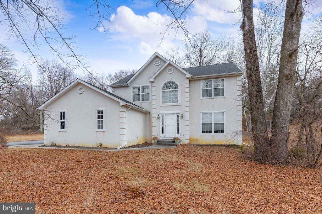 view of front of house featuring entry steps and stucco siding