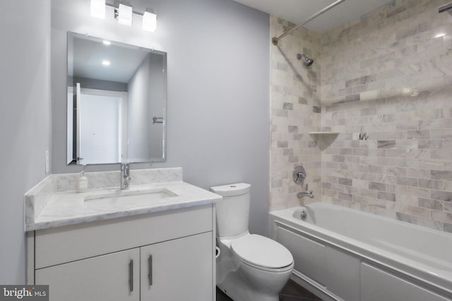 bathroom with toilet, shower / bathing tub combination, and vanity