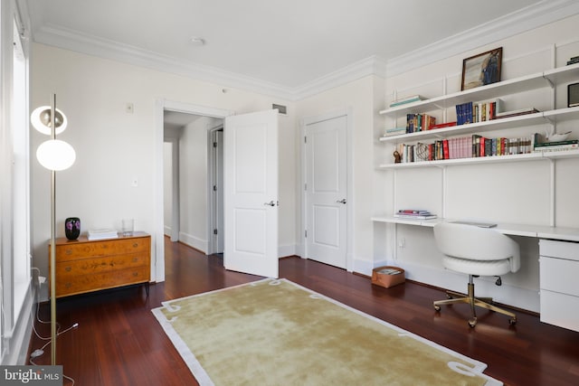 office featuring ornamental molding, built in desk, wood finished floors, and visible vents