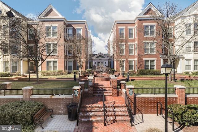 surrounding community with a yard and a fenced front yard