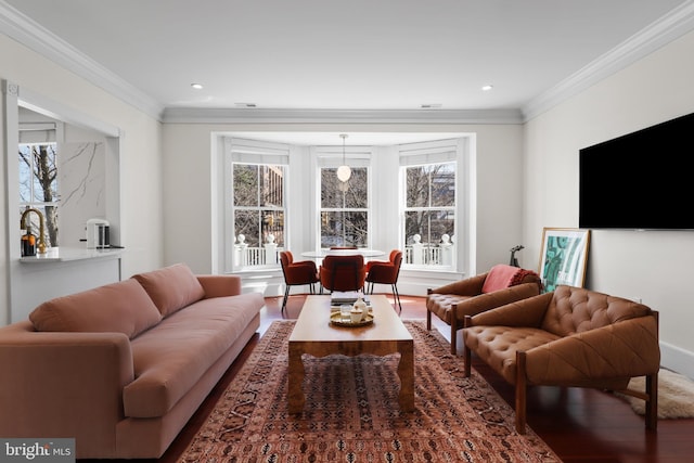 living room with ornamental molding, wood finished floors, and recessed lighting