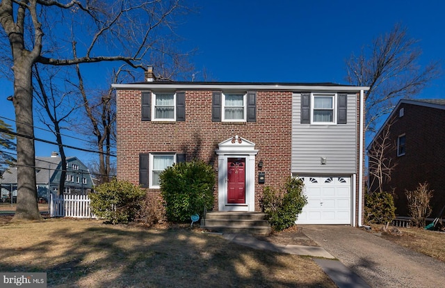 view of front of property featuring a garage, fence, aphalt driveway, and brick siding