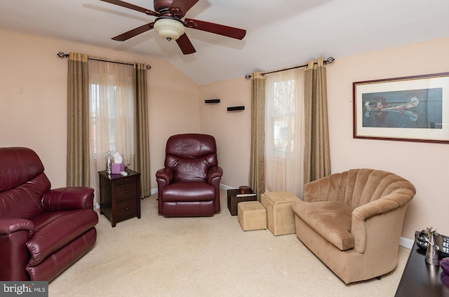 sitting room with vaulted ceiling, carpet floors, ceiling fan, and baseboards