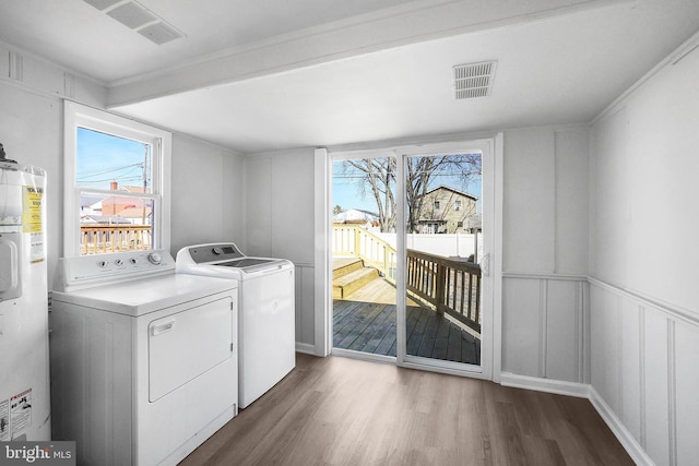 washroom featuring laundry area, plenty of natural light, visible vents, and separate washer and dryer