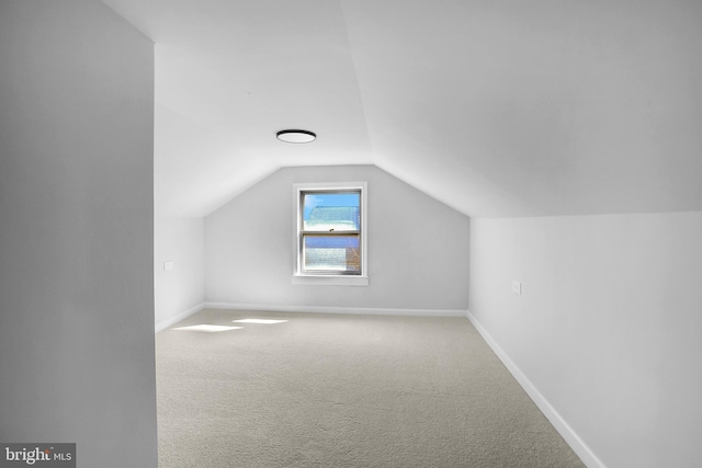 bonus room with carpet, lofted ceiling, and baseboards