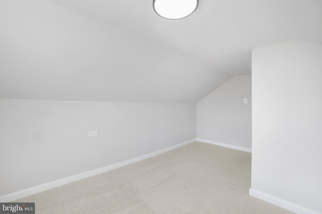 bonus room featuring lofted ceiling, baseboards, and carpet flooring