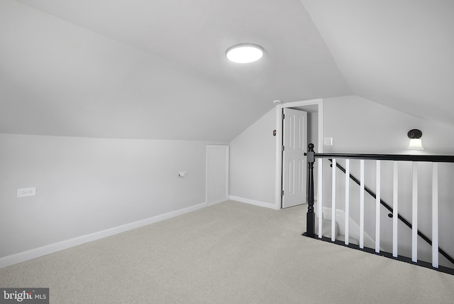 additional living space with lofted ceiling, carpet, and baseboards