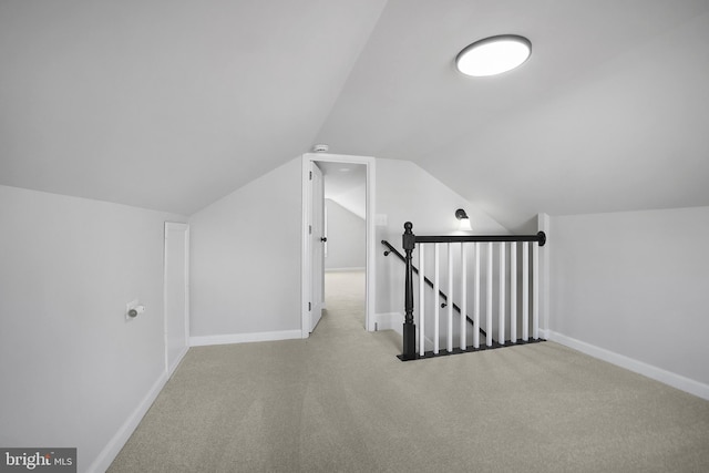 additional living space featuring lofted ceiling, carpet flooring, and baseboards