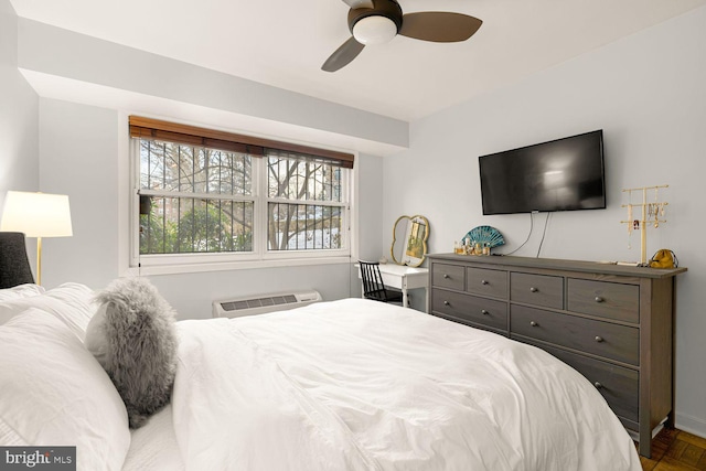 bedroom with a ceiling fan and a wall mounted AC