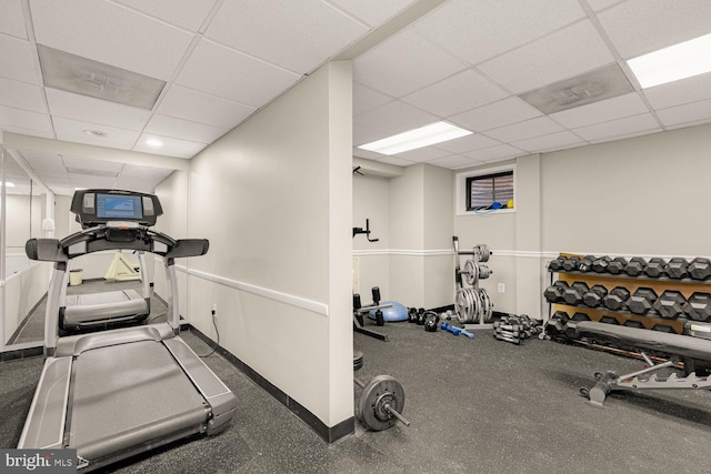 workout area with baseboards and a drop ceiling