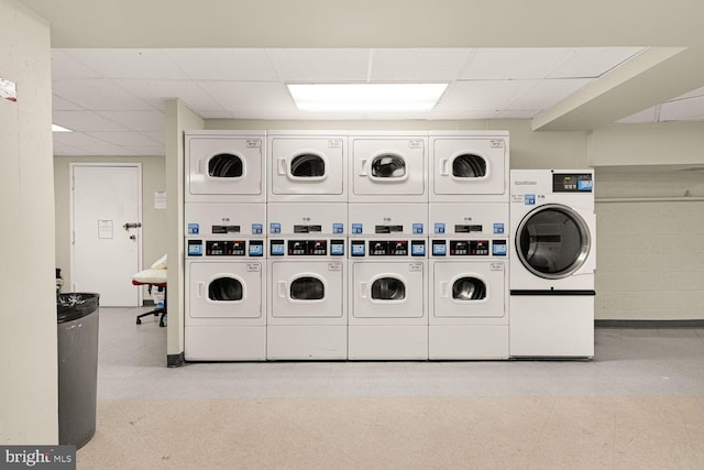 shared laundry area with washer and dryer, stacked washer / dryer, and tile patterned floors