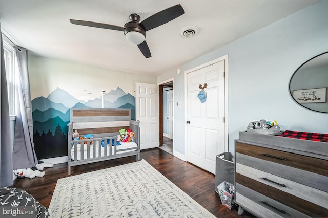 bedroom featuring visible vents, baseboards, and wood finished floors