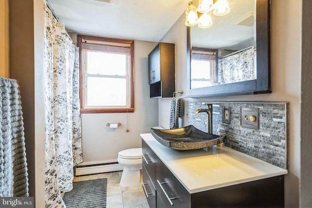 bathroom featuring a baseboard radiator, vanity, toilet, and decorative backsplash