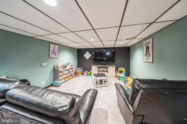 carpeted living area with recessed lighting and a paneled ceiling