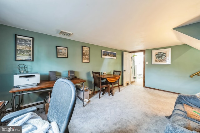 carpeted office with visible vents and baseboards