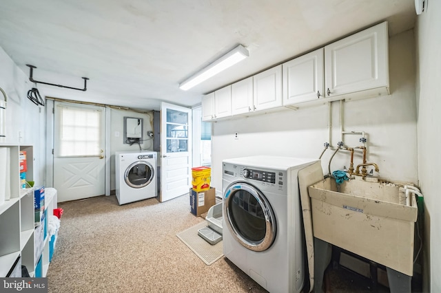 laundry area with a sink, washing machine and dryer, and cabinet space