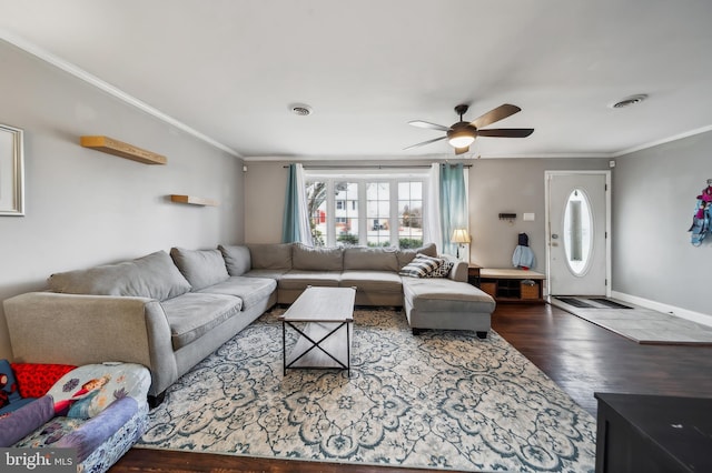 living room featuring baseboards, visible vents, crown molding, and wood finished floors