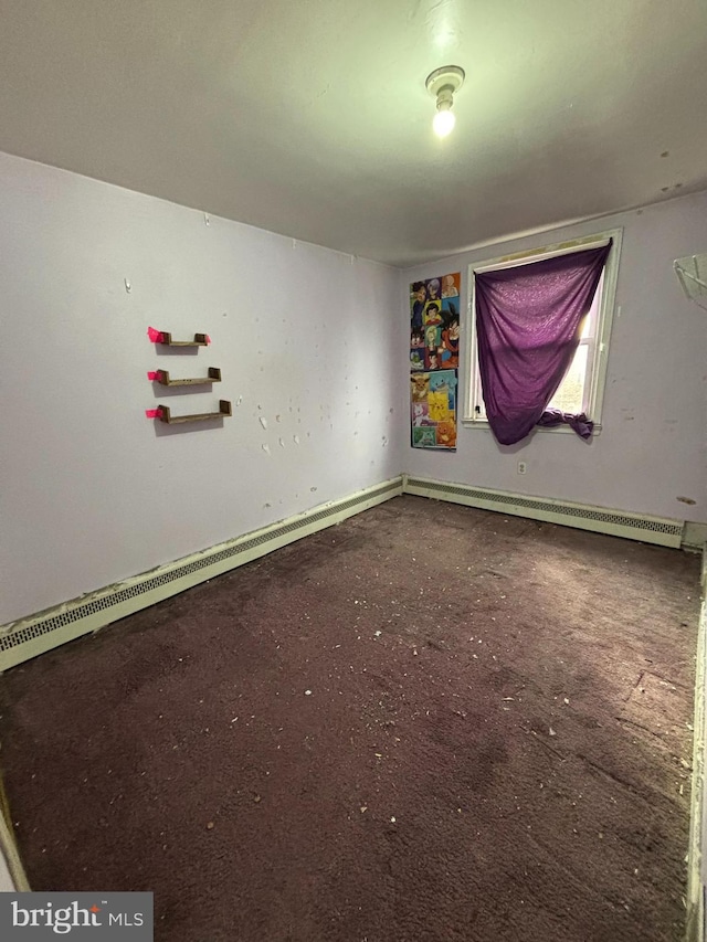 empty room featuring a baseboard heating unit