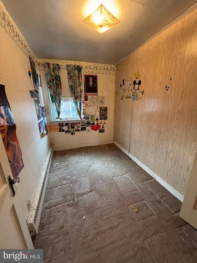 empty room with a baseboard radiator and baseboards